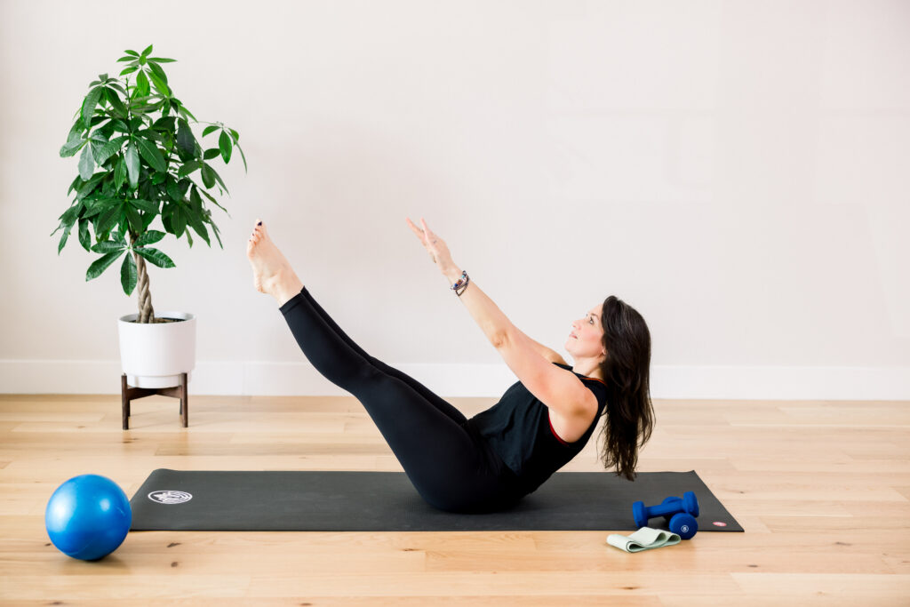 Pilates instructor in a pose, in her studio.
