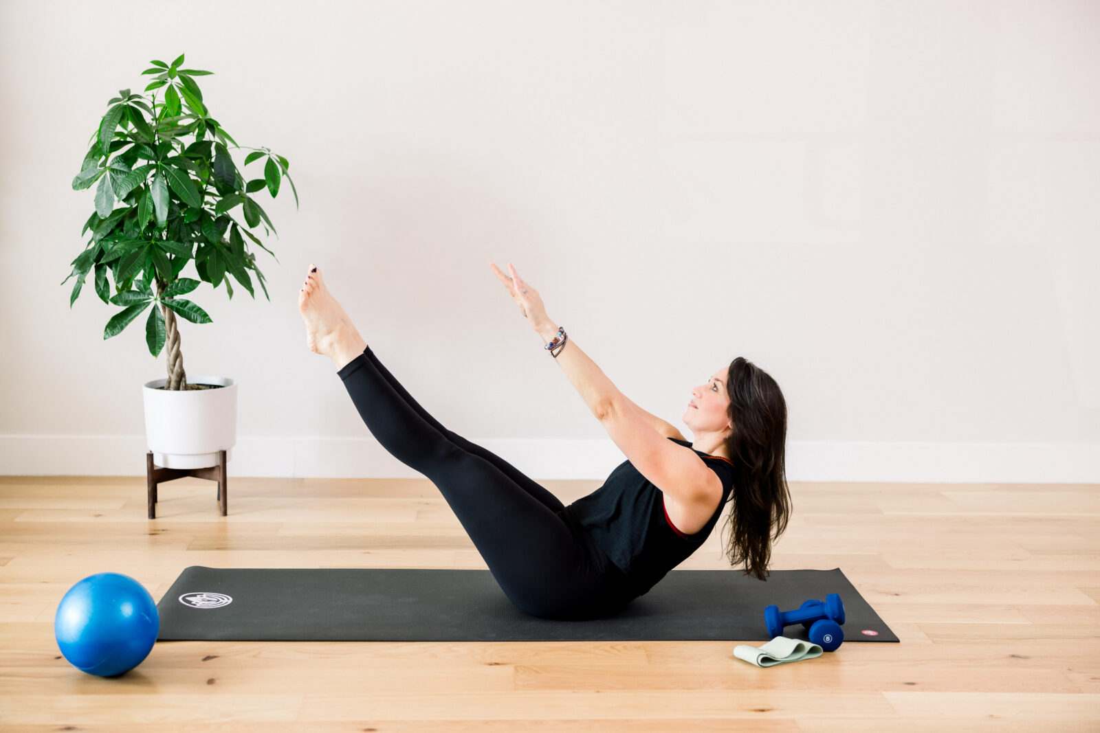 A yoga and pilates instructor in her studio during a brand photography session in Alexandria VA.