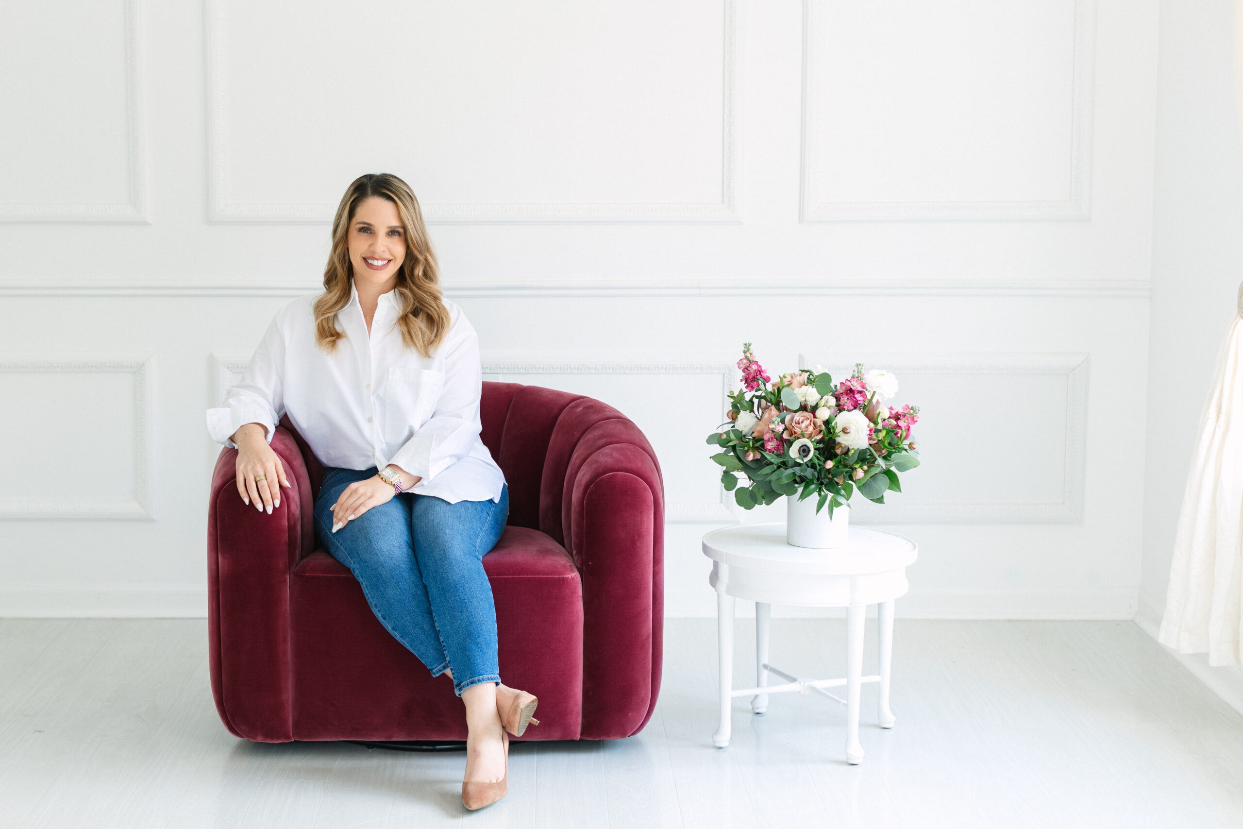  A female psychologist, looking professional yet approachable, sat in a rose velvet chair.