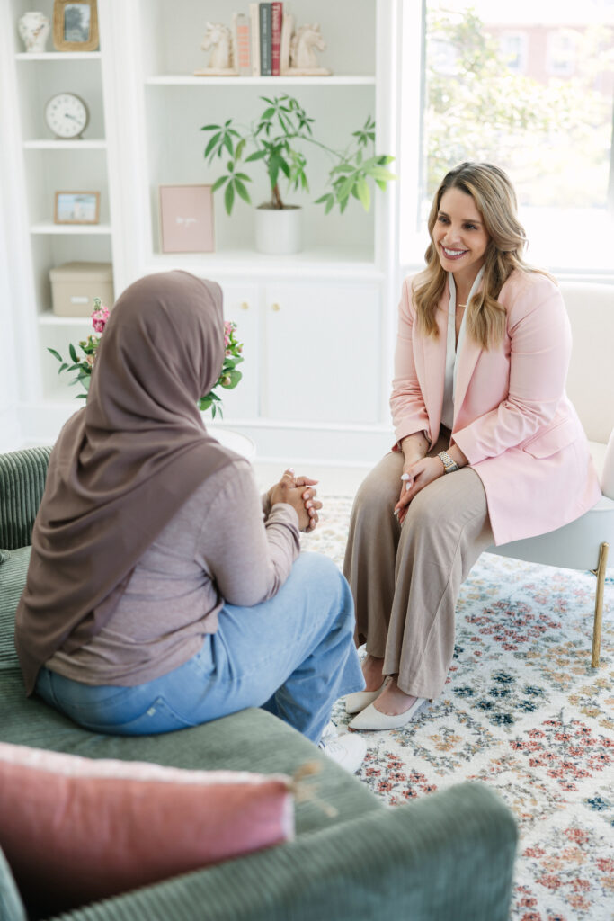A psychologist showing her warm, understanding demeanor during a consultation with a client.
