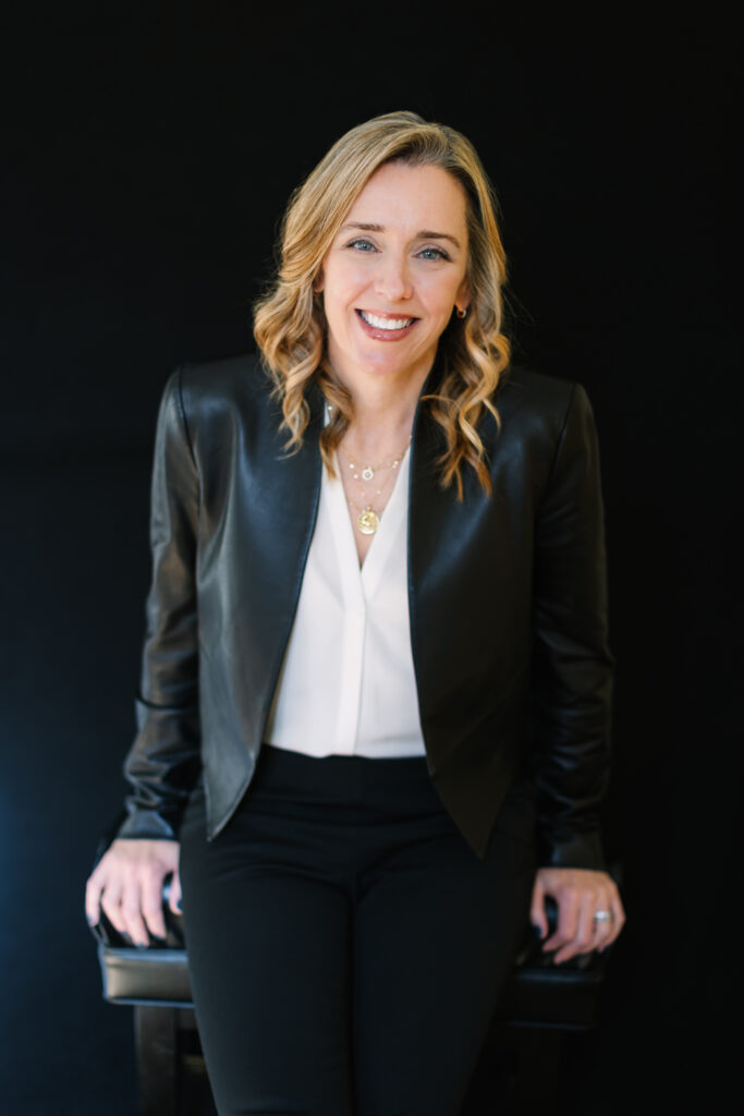 A woman against a black backdrop during a professional headshot session in DC & VA