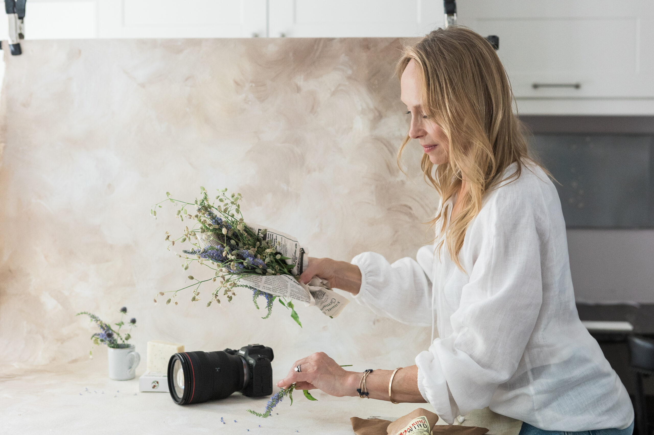 A Northern Virginia, Brand Photographer setting up props for a professional brand photo shoot.
