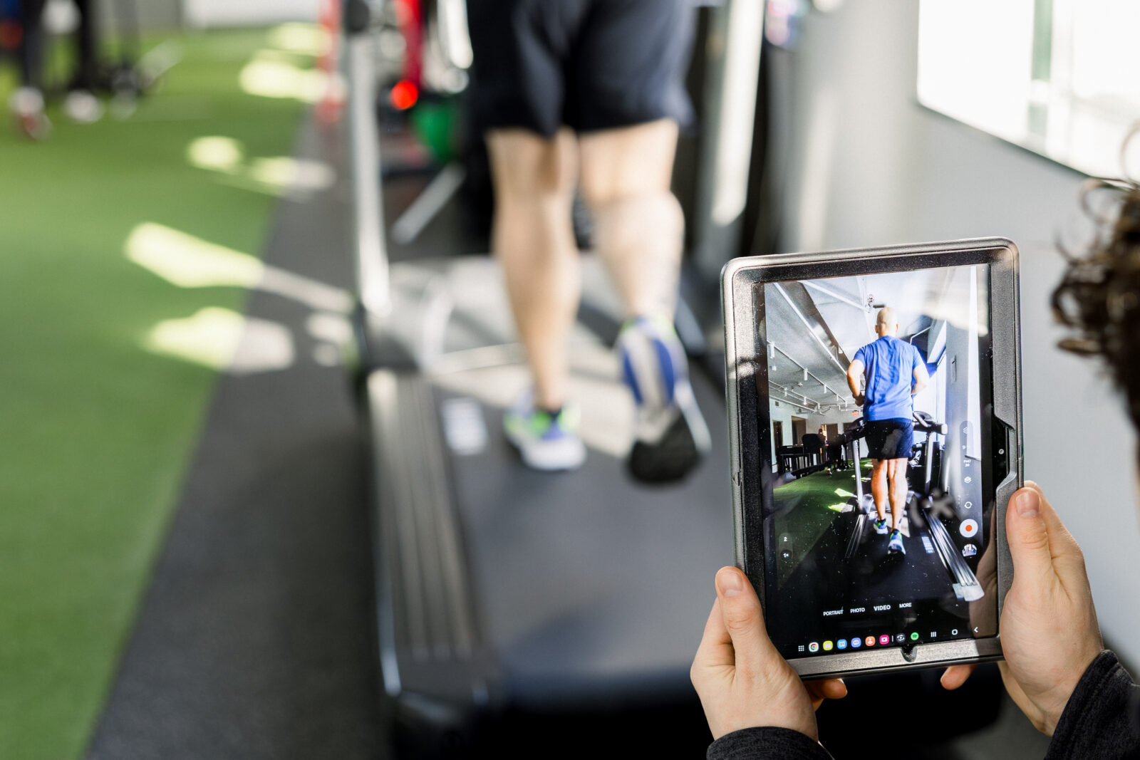 A runner on a treadmill, undergoing a running analysis
