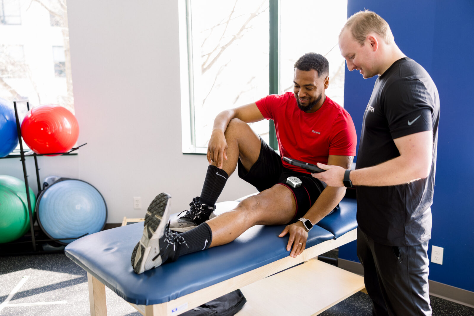 Blood flow restriction on a man's leg at a physical therapy practice