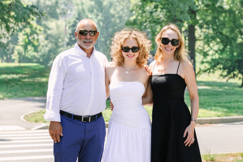a graduate with her parents