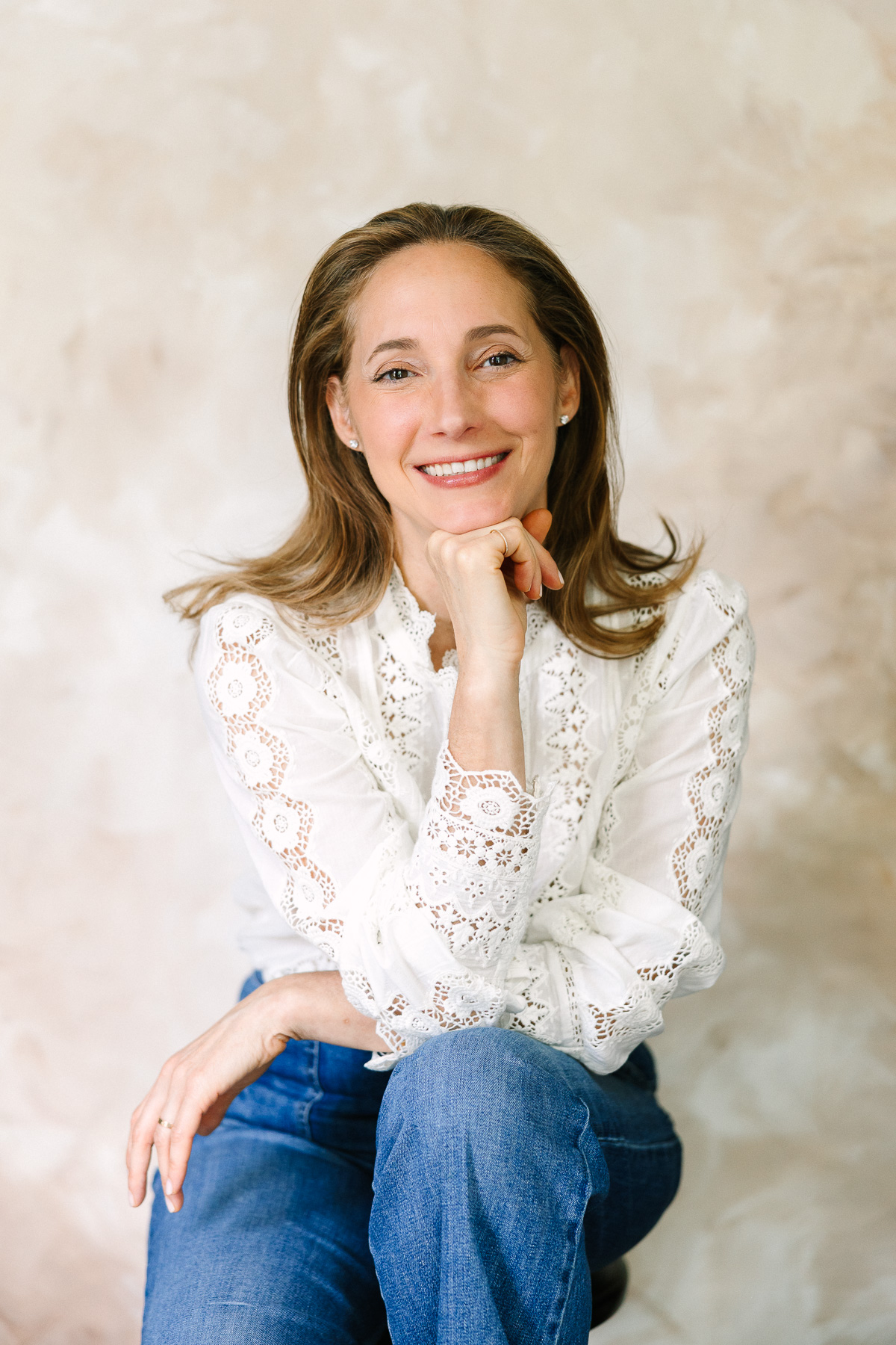 Professional headshot of wellness coach Betty Bramos smiling during a brand photography session.